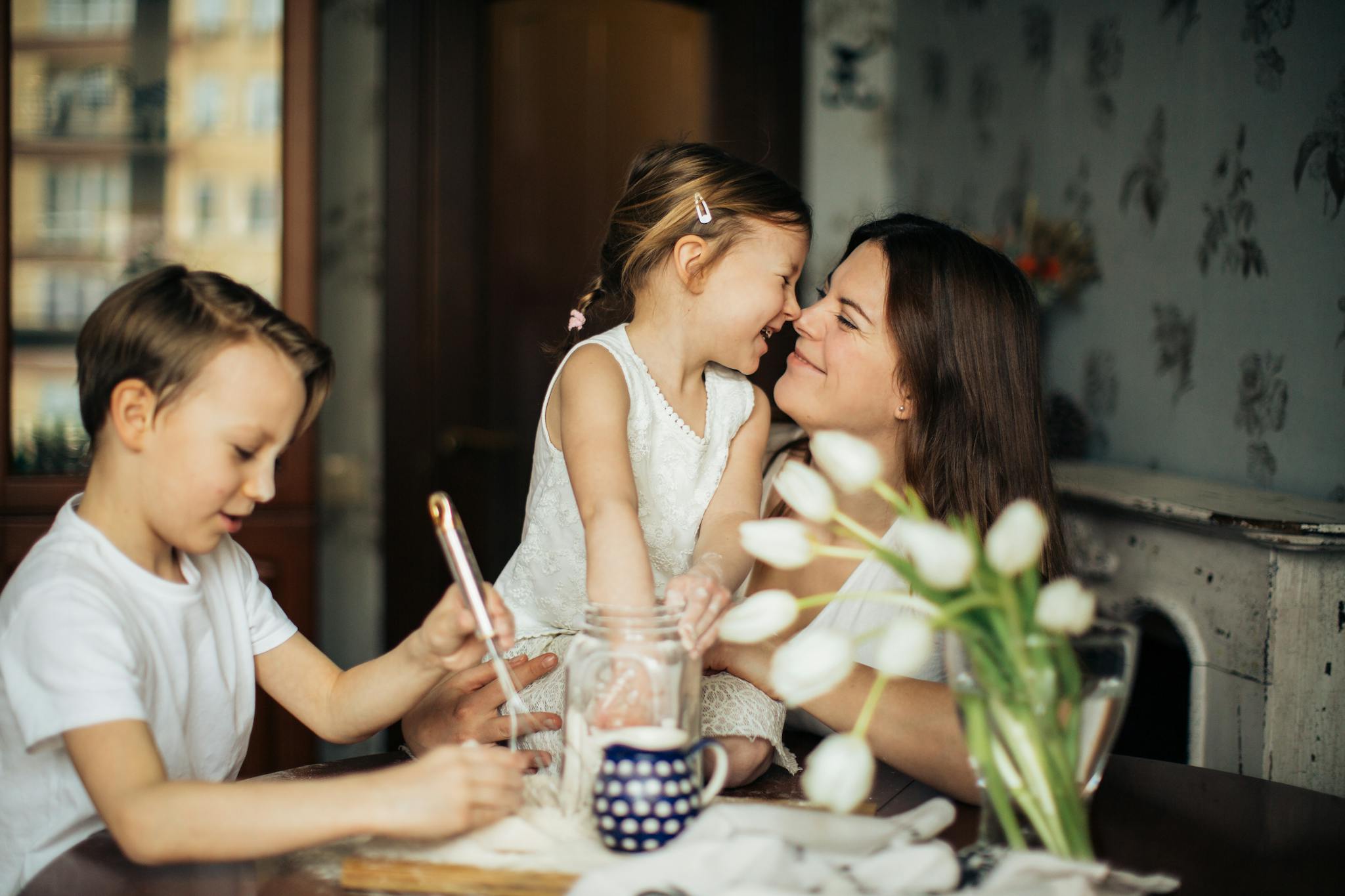 About 1 A joyful moment of a mother baking with her children in a cozy home environment.
