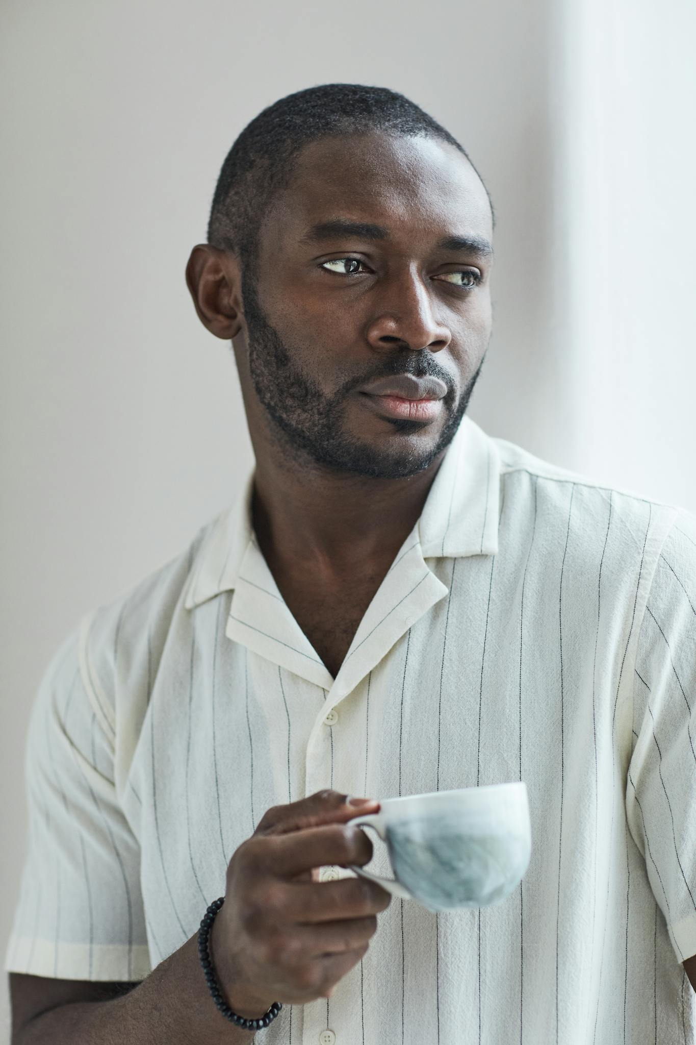 About 7 african american man enjoying a cup of