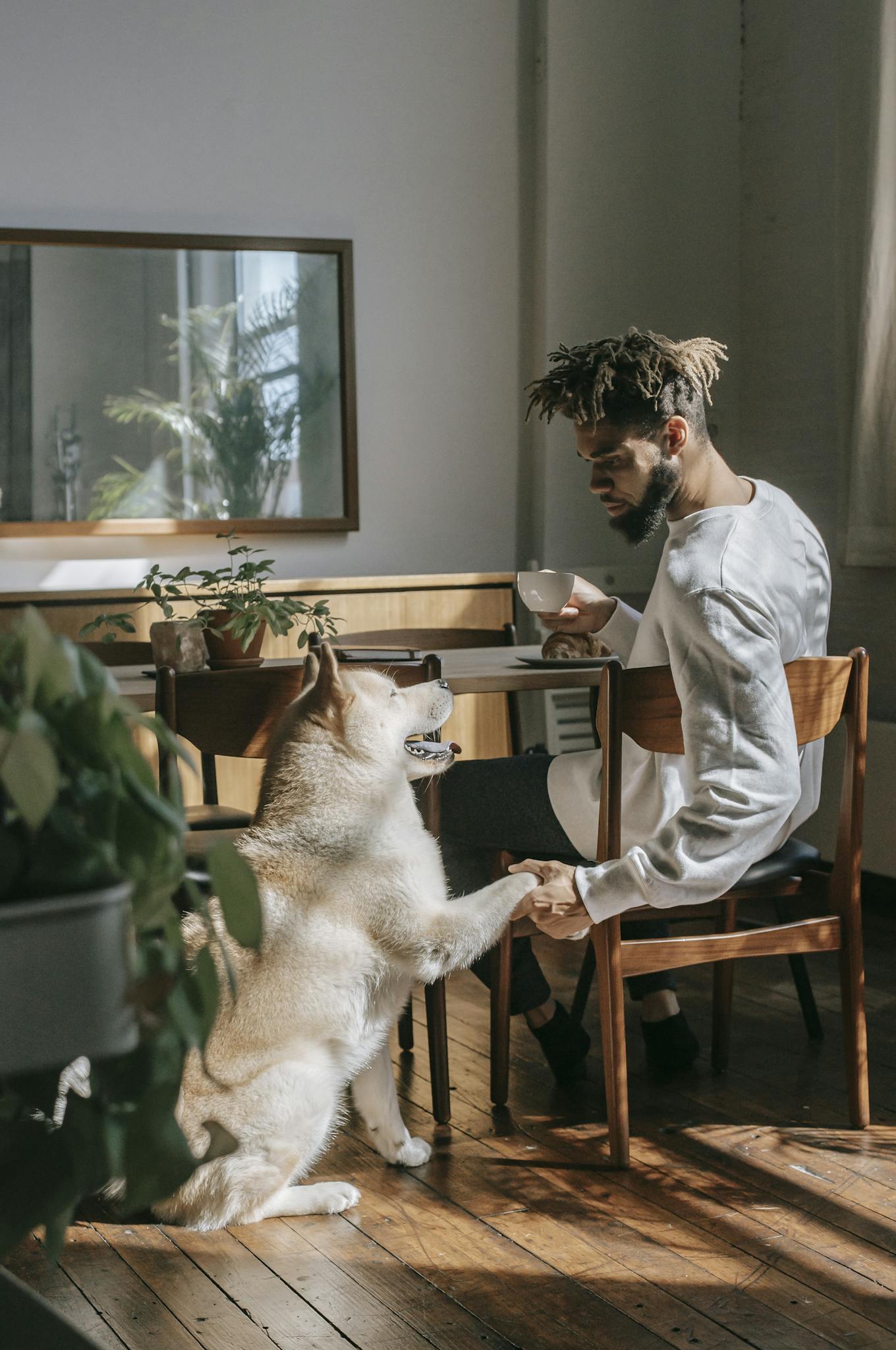 About 5 man enjoying coffee indoors with his friendly